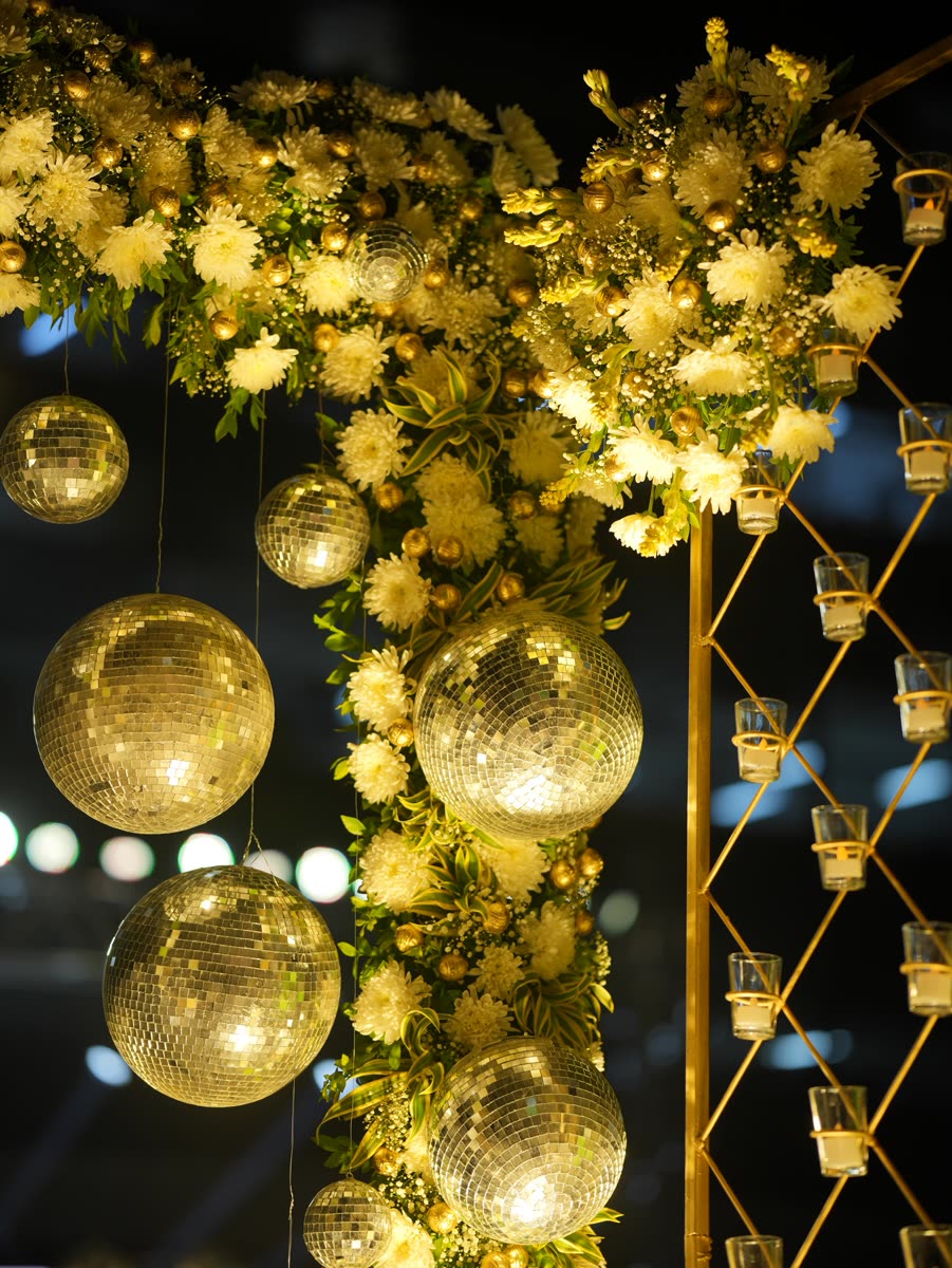 Gold mirror-balls and blossom lit up at night