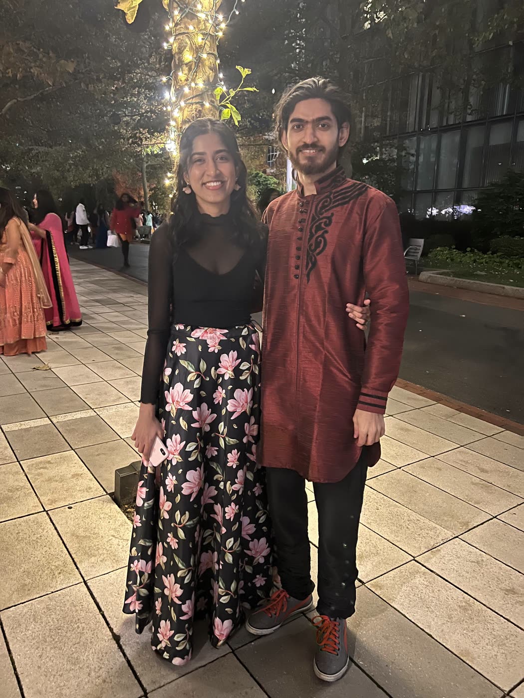 Abirami and Prateek in festive Indian wear under string lights