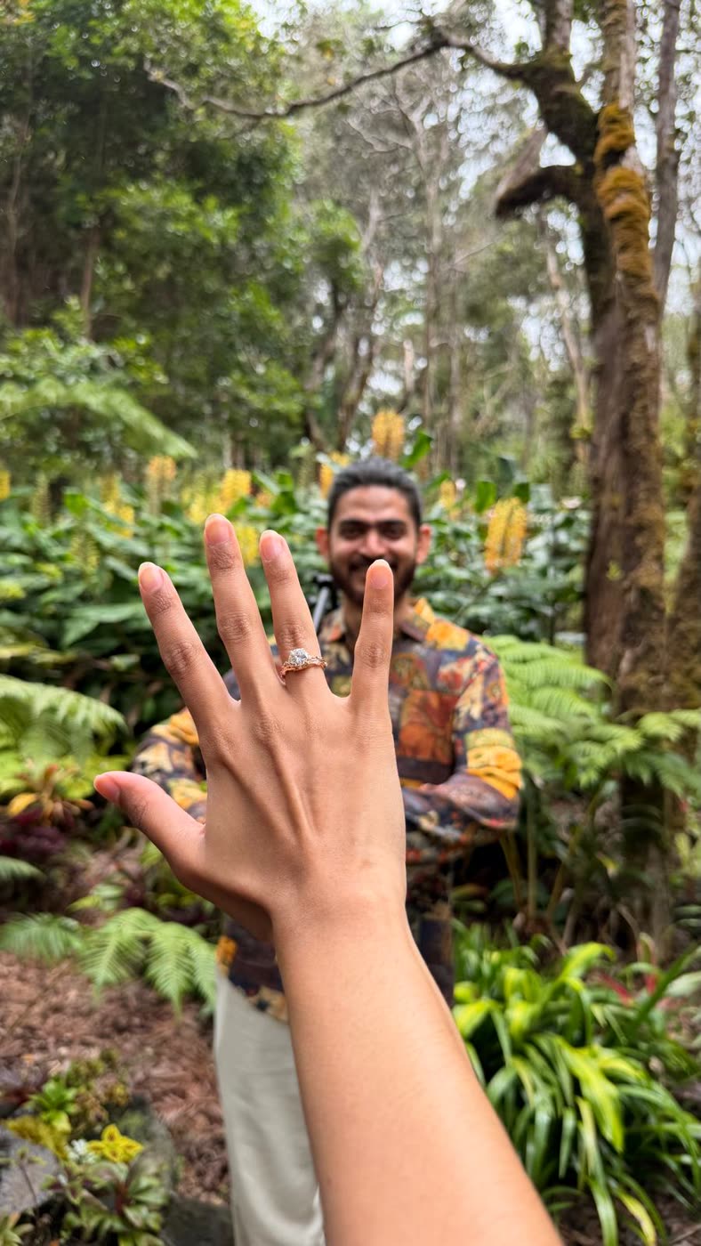 Abirami showing her engagement ring in a Hawaiian garden