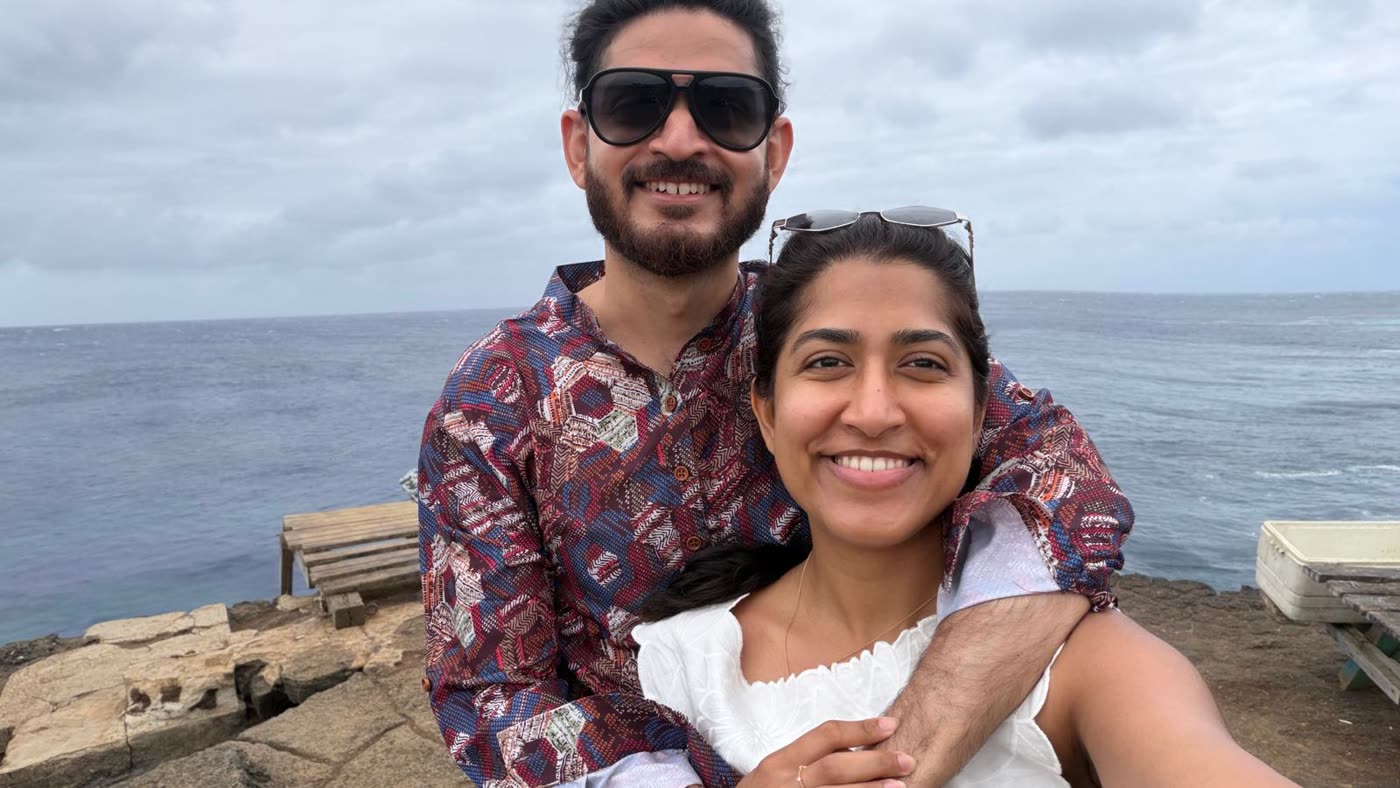 Abirami and Prateek on the rocks by the sea