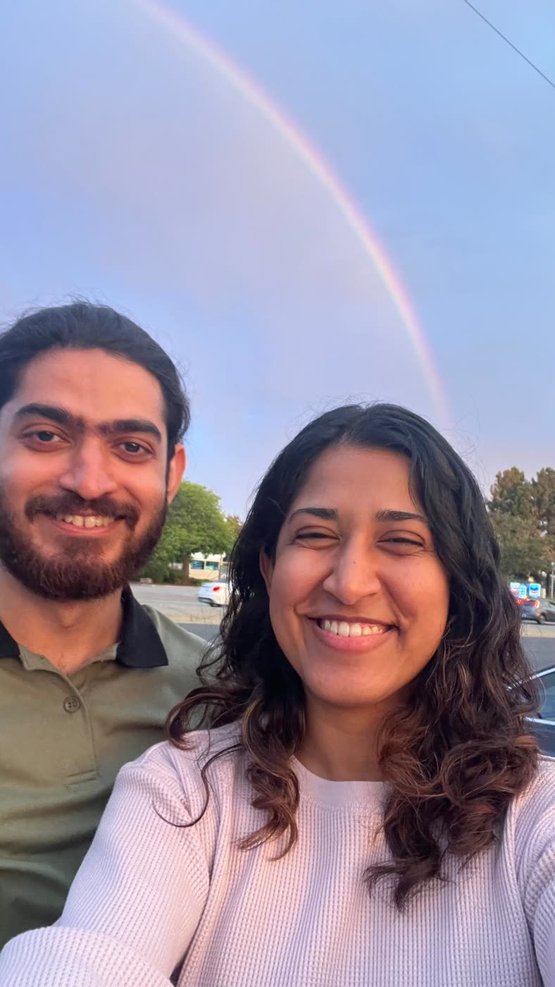 Abirami and Prateek under a rainbow